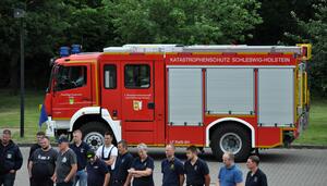 Katastrophenschutzfahrzeug mit Kamerad*innen